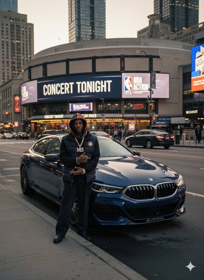MINDBENDA in streetwear beside a dark blue BMW outside a city arena